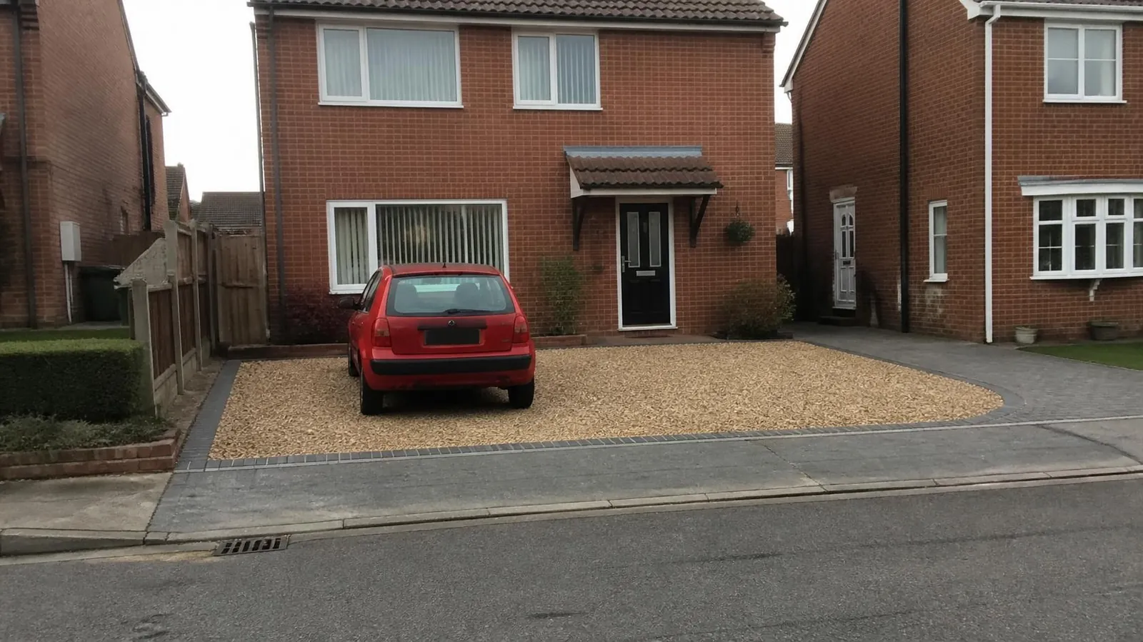 Example image: gravel driveway with sett edging and a solid block apron at the pavement