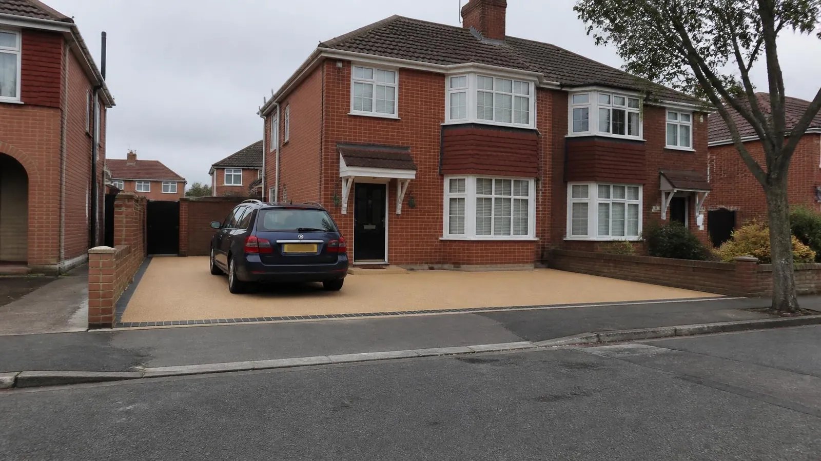 Example image: red-brick bay-fronted semi with a new block-paved driveway leading to the front door
