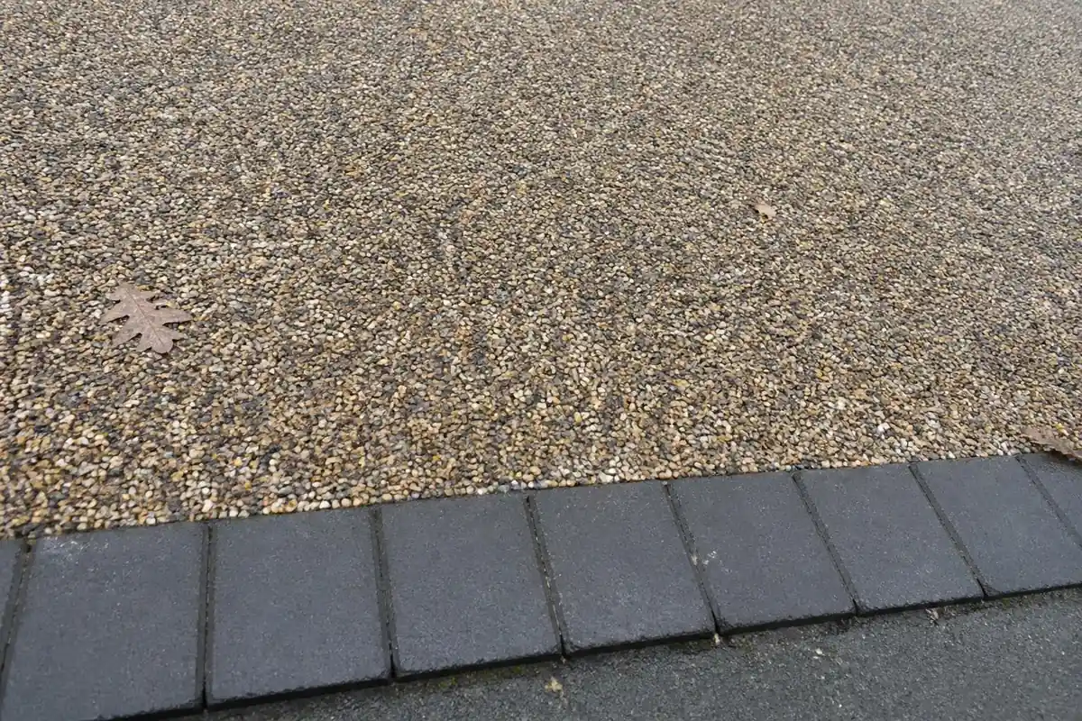 Example image: close-up of resin-bound stone surface with a block paving edge