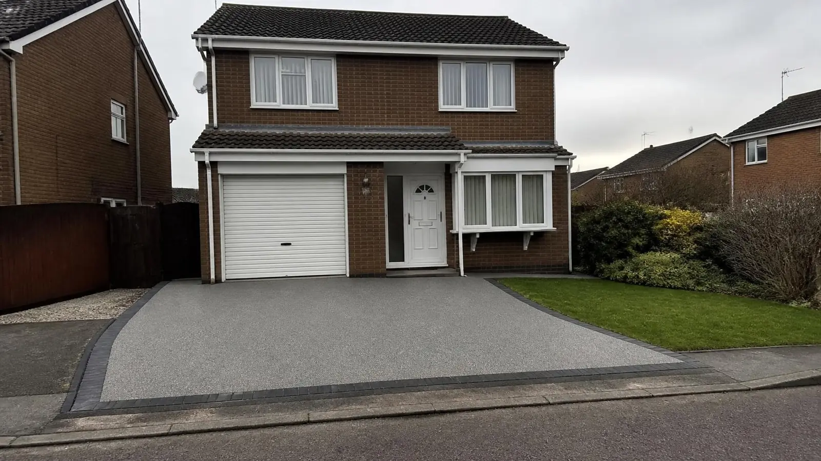 Example image: buff resin-bound driveway leading to the front door of a brick semi